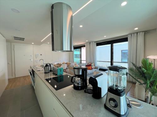 a kitchen with a counter with a blender on it at Faro Design 1 by Homing in Faro