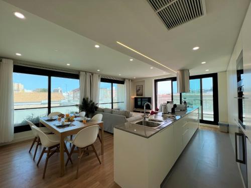 a kitchen and living room with a table and chairs at Faro Design 2 by Homing in Faro
