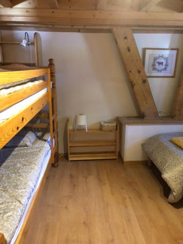 two bunk beds in a room with wooden floors at Central Hostel Chatel in Châtel