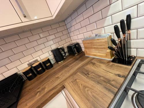 a kitchen with a counter with knives on a counter top at Stylish One Bedroom Central Bournemouth Flat in Bournemouth