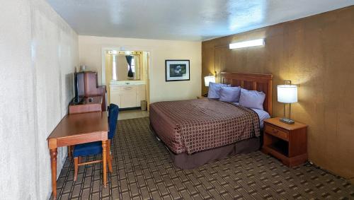 a hotel room with a bed and a desk at M Star Hotel Cleveland in Cleveland