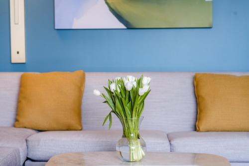 a vase of white flowers sitting on a table at Hotel Madera in Washington