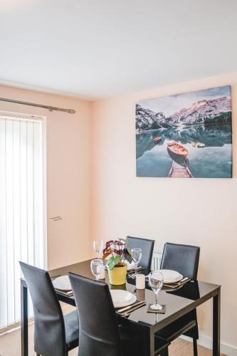 a dining room with a table and chairs at Snapos Apartments - Tudor Close in Carbrook