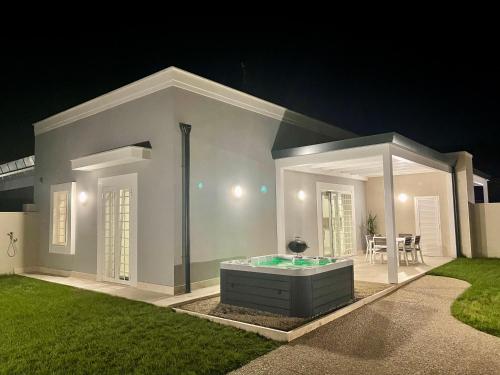 a house with a hot tub in the yard at night at Domus Lavinia ''Scirocco'' - Anzio in Anzio