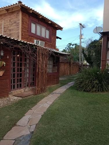 a house with a walkway in front of a yard at Solar Lisboa 100 m da Praia com vista para mar in Balneário Camboriú
