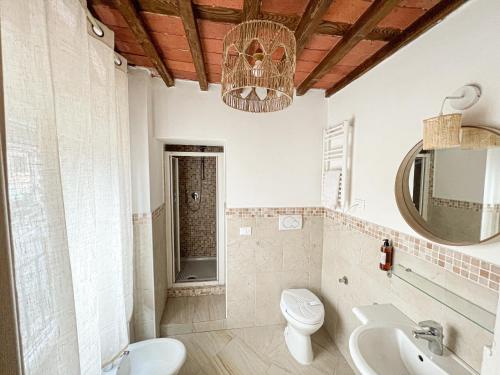 a bathroom with a sink toilet and a mirror at NEW! -Verderame Rooms & Suite in Lucca in Lucca