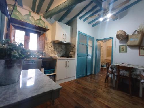 a kitchen with white cabinets and a blue ceiling at Riojania Heredad in Santa Eulalia Bajera