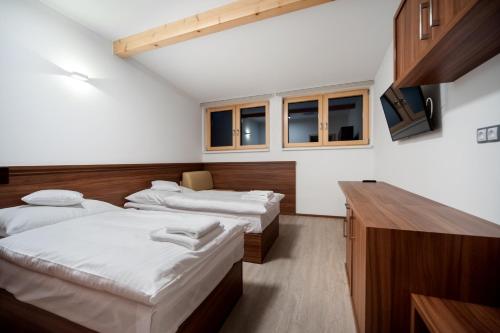 Ein Bett oder Betten in einem Zimmer der Unterkunft Vinařský dům, Vinařství Popela Perná
