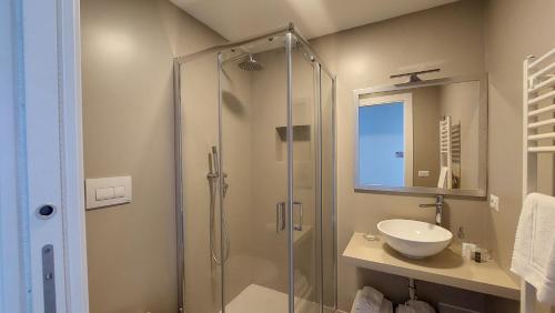 a bathroom with a glass shower and a sink at D-Home Ortigia in Siracusa