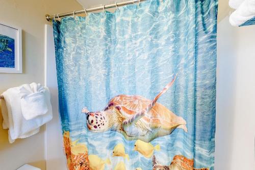 a shower curtain with a sea turtle in the water at Lamplighter Inn II in Bandon