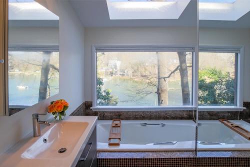 a bathroom with a tub and a large window at Chase Creek Retreat in Annapolis