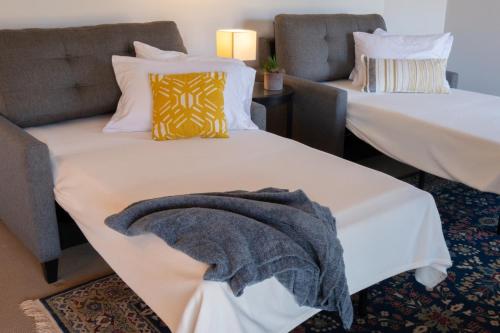 two beds in a room with a blanket on the bed at Chase Creek Retreat in Annapolis