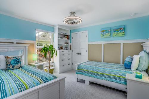 a bedroom with blue walls and a bed and a window at Smiles and Sunshine in Cape Coral