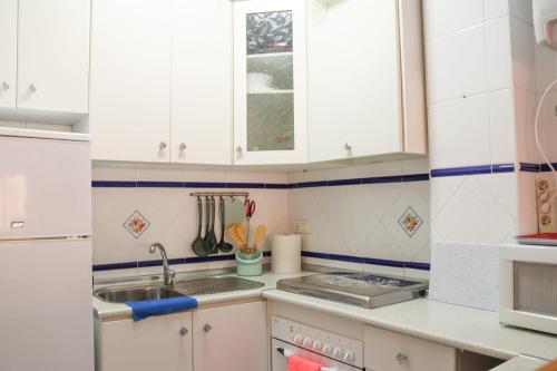a kitchen with white cabinets and a sink at LA CASITA DEL CABO in El Cabo de Gata