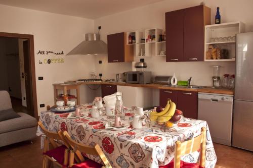 a kitchen with a table with bananas on it at Marameo B&B in Udine