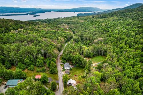 an aerial view of a house and a road in the forest at Adirondack Sugar Shack in Diamond Point