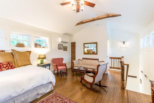 a bedroom with a bed and a table and chairs at The Barn in Waynesville