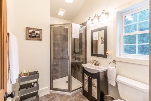 a bathroom with a shower and a sink at The Barn in Waynesville