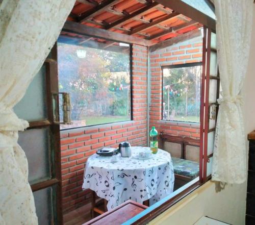 a small table in a room with a window at Chácara Felicidade in Socorro