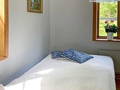 a bed with a pillow on it in a room at 6 person holiday home in Vislanda-By Traum in Vislanda