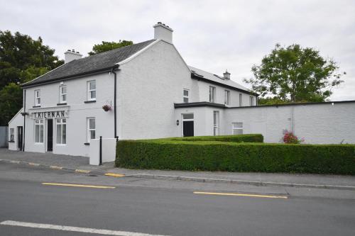 a white building on the side of a street at Kiernan's Self Catering & Accommodation in Legan