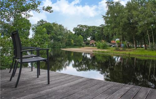 a chair sitting on a dock next to a lake at Gorgeous Home In Heel With Wifi in Heel