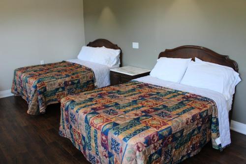 a hotel room with two beds in a room at Sauble Beach Lodge in Sauble Beach