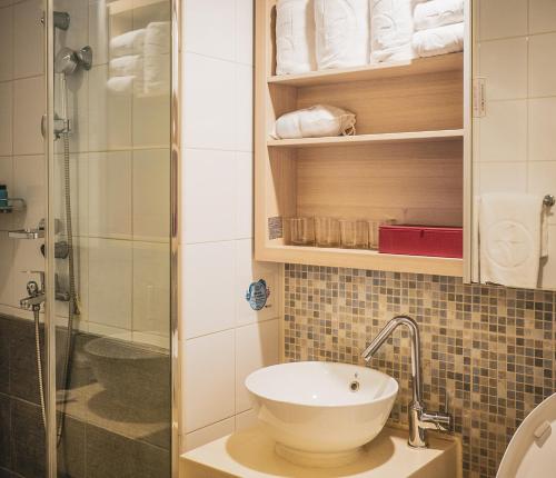 a bathroom with a toilet and a glass shower at Ramada by Wyndham Seoul Dongdaemun in Seoul