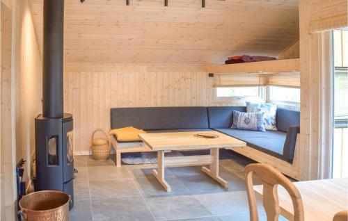 a living room with a blue couch and a wood stove at Lovely Home In Mesnali With Kitchen in Mesnali