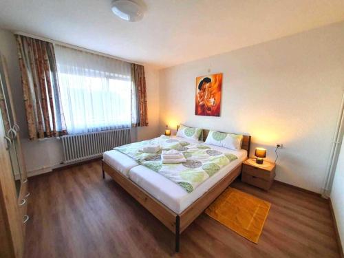 a bedroom with a large bed and a window at Comfortable flat in Görwihl with balcony in Görwihl