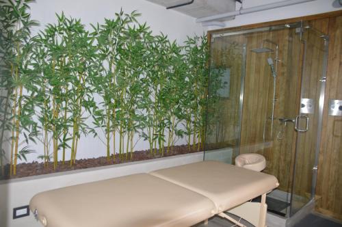 a bathroom with a shower and a bench and a wall with bamboo at Cozy Stays Cayala Apartments (407) in Guatemala