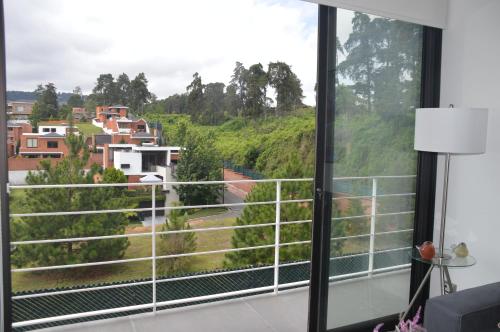 a room with a window with a view at Cozy Stays Cayala Apartments (407) in Guatemala