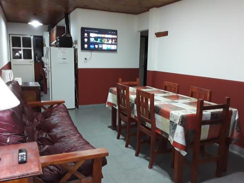 comedor con mesa, sillas y sofá en La Elegida con quincho y cochera en Esquel