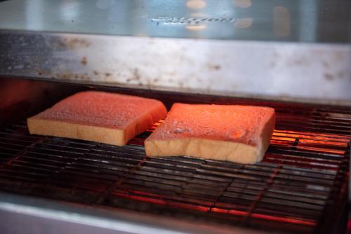 two slices of bread cooking in an oven at The Legacy River Kwai Resort in Kanchanaburi