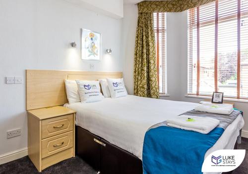a bedroom with a large bed and a window at Dene Hotel in Newcastle upon Tyne
