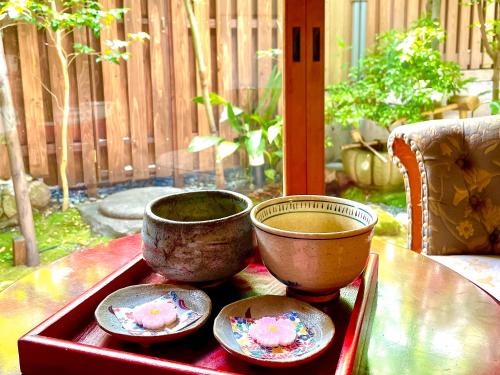 a tray with three bowls on top of a table at Kappo Ryokan Yumesaki in Beppu