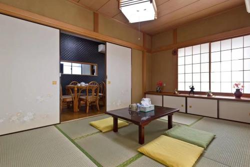 a living room with a table and a dining room at japan house shinkoiwa guest house in Tokyo