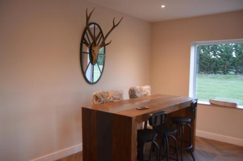 a dining room with a table and a mirror on the wall at The Bunkhouse - 2 bedroom home with parking in Worcester