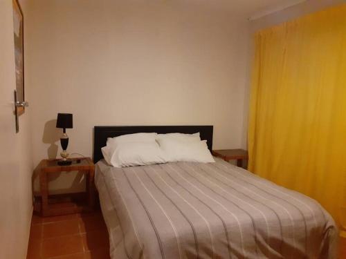 een slaapkamer met een bed en een geel gordijn bij Blue Lantern Ramsgate in Margate