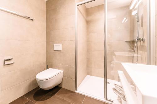 a bathroom with a toilet and a shower at LOOMZ living Self-check-in in Innsbruck