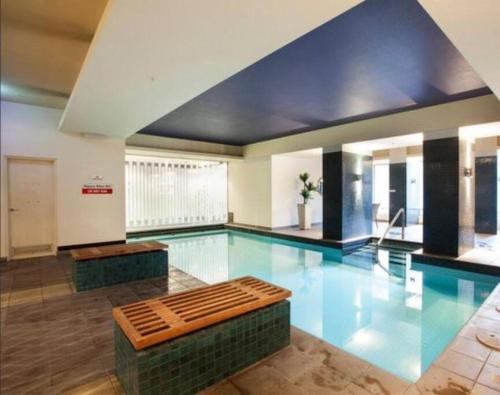 a swimming pool with a bench in the middle of it at Southbank Melbourne Gem in Melbourne