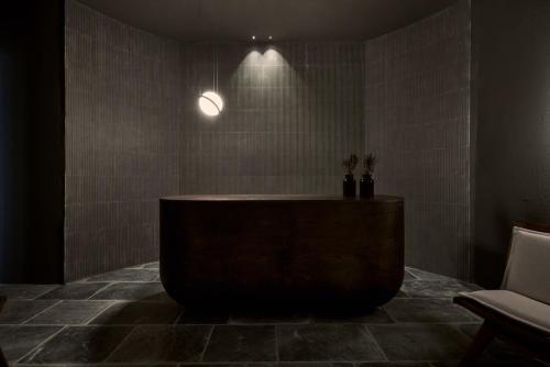a bathroom with a tub in the middle of a room at Archipelagos All Suites in Elia Beach