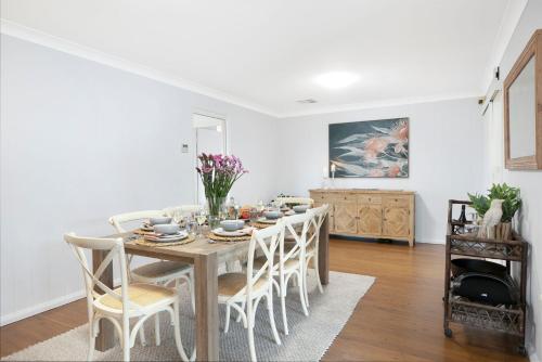 a dining room with a table and chairs at Hillside Farm in Mittagong