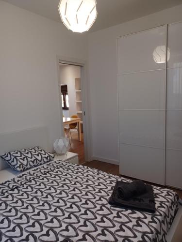 a bedroom with a bed with a black hat on it at Apartman B & S with a beautiful terrace in Pula