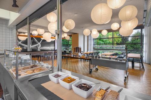 a restaurant with a counter with food on display at Luzern Youth Hostel in Luzern