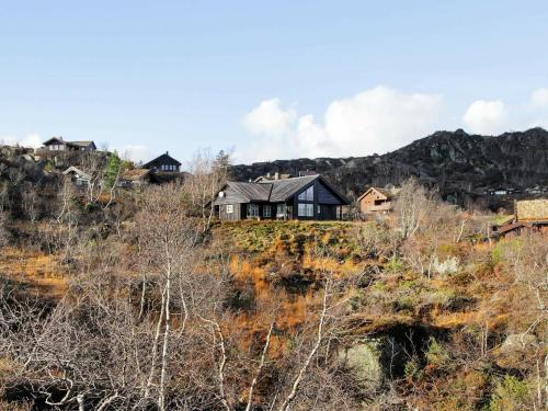 a house sitting on top of a hill at 10 person holiday home in SERAL in Åseral