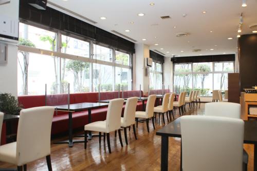 a dining room with a long table and chairs at Rembrandt Style Tokyo Nishikasai in Tokyo