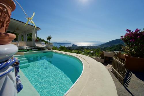 a swimming pool on the side of a house at Relais Villa Ettore in Ischia