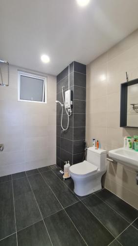 a bathroom with a toilet and a shower and a sink at Centre of Sri Petaling in Kuala Lumpur
