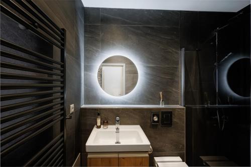 a bathroom with a sink and a mirror at TRI VODY Demänovská Dolina in Liptovský Mikuláš